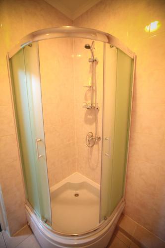 a shower with a glass enclosure in a bathroom at Formula 1 in Ivano-Frankivsʼk