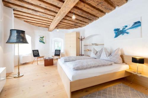 a bedroom with a large bed and wooden ceilings at Residenz Schloss Pöggstall in Pöggstall