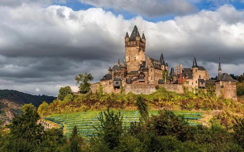 a castle on top of a hill at Living in the historic Cochem Old Town in Cochem