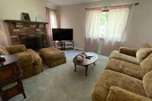 a living room with a couch and a fireplace at Nikki's House in Cincinnati