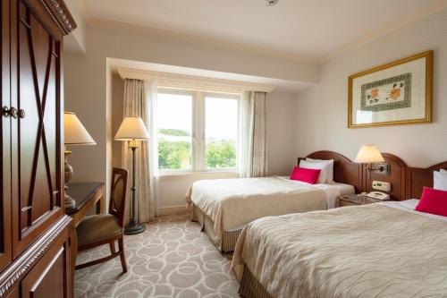 a hotel room with two beds and a window at Sendai Royal Park Hotel in Sendai