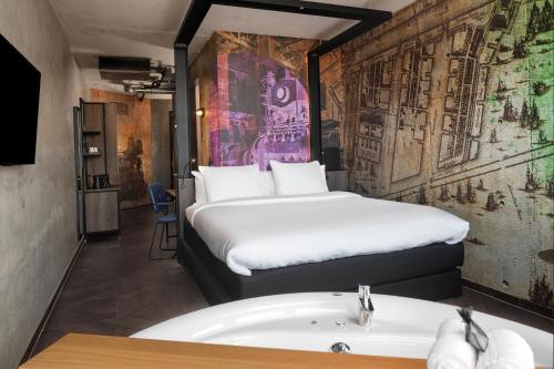 a hotel room with a bed and a sink at Inntel Hotels Amsterdam Landmark in Amsterdam