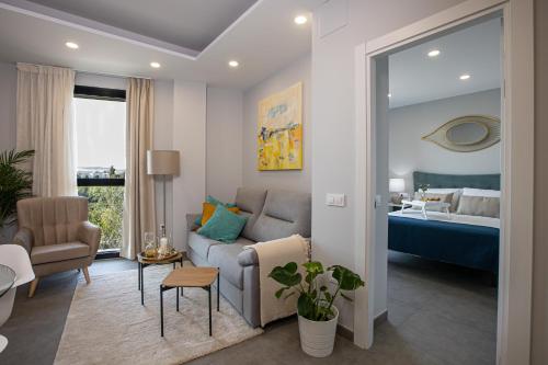 Posteľ alebo postele v izbe v ubytovaní Apartamentos Ribera 19