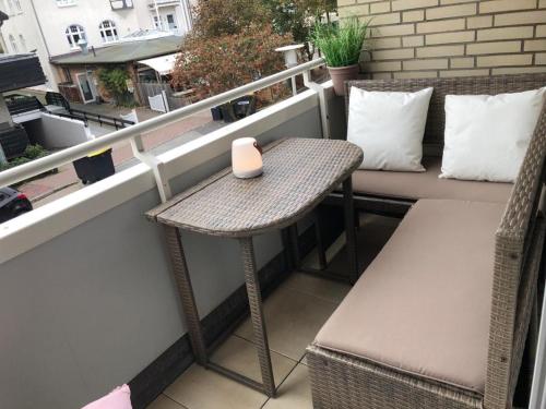 einen kleinen Tisch auf einem Balkon mit einer Kerze drauf in der Unterkunft Seerose in Westerland