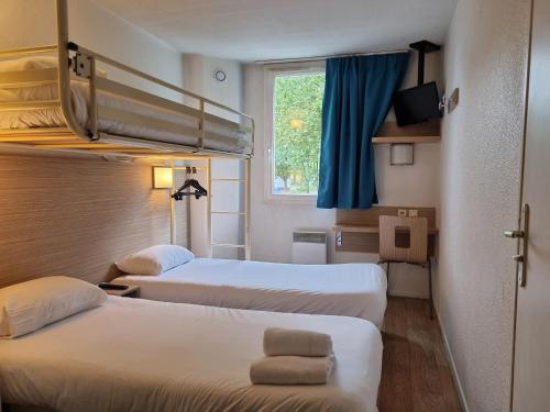 a hotel room with two beds and a window at CYAN HOTEL - Roissy Villepinte Parc des Expositions in Roissy-en-France