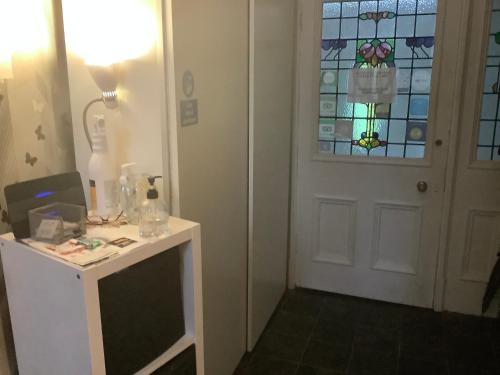 a room with a desk and a door with a window at Nethermains House in Kilwinning