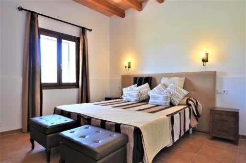 a bedroom with a large bed and a window at CAS BORRASSOS- Finca con piscina privada y Vistas Despejadas in Palma de Mallorca