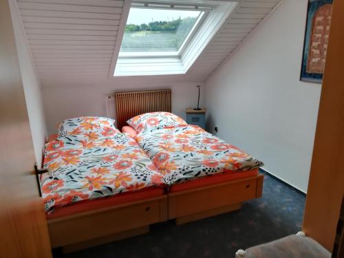 a bed in a room with a window at Apartment Preising in Willingen