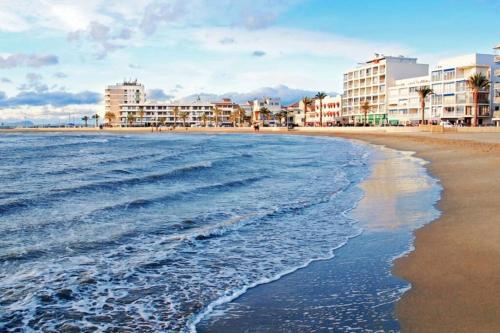 a view of the beach with hotels and buildings at myinsolite - Tiny-house, jacuzzi, brasero, piscine in Aigues-Mortes