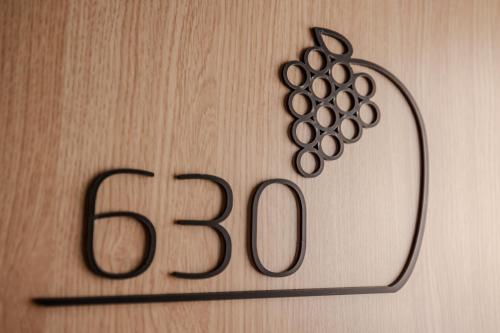 a sign with a bunch of grapes on a wall at Quality Hotel Hasle Linie in Oslo