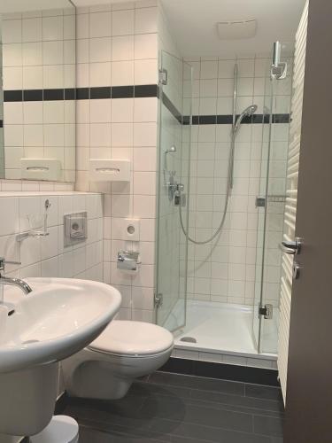 a bathroom with a shower and a toilet and a sink at Buhlsche Mühle in Ettlingen