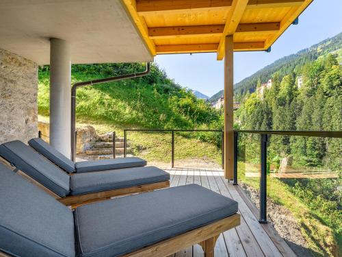 a room with a balcony with a view of a mountain at Das Schider - Boutique Apart-Hotel in Bad Gastein