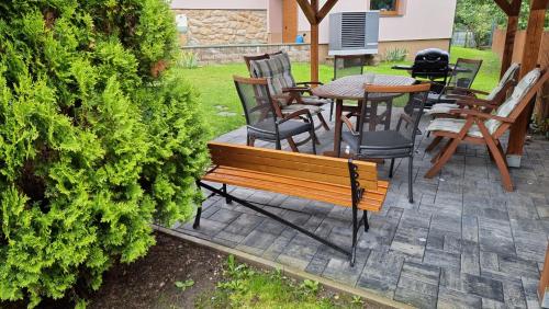 a bench and tables and chairs on a patio at U Pařeza in Ludvíkovice
