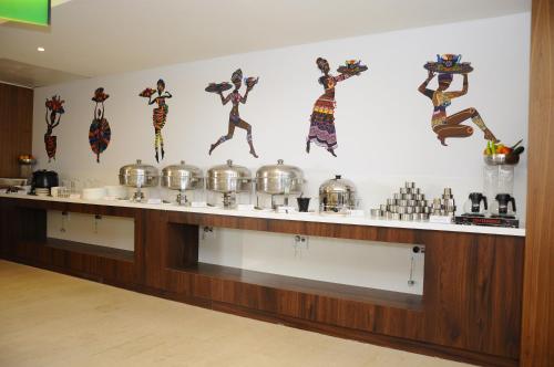 a kitchen with a counter with pots and pans at ZIBE Salem By GRT Hotels in Salem