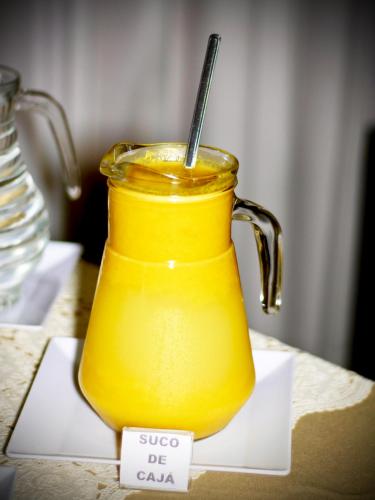 a yellow jar of orange juice on a table at Jalapão Hotel in Palmas
