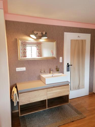a bathroom with a sink and a mirror at Ferienhof Moyer in Höslwang