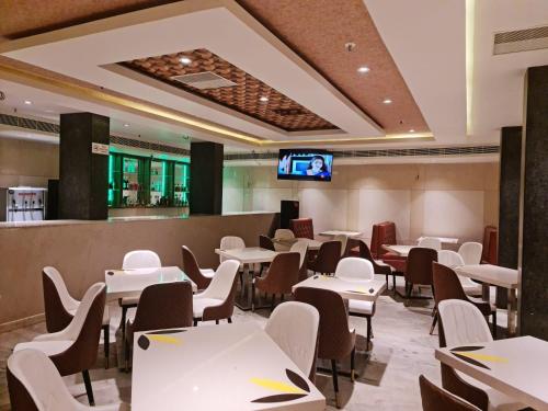 a dining room with white tables and chairs at THE HOTEL PARK in Kolachel