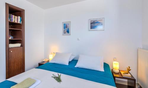 a bedroom with a bed and a book shelf at Villa Lefki in Vamos