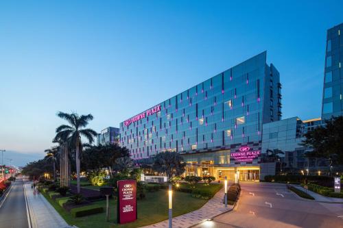 a building on a city street at night at Crowne Plaza Guangzhou Huadu by IHG - Free Shuttle bus between hotel to Exhibition Center During Canton Fair in Guangzhou