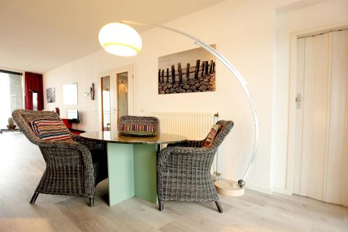 a dining room with a table and chairs at Kustverhuur, Appartement aan zee, Port Scaldis 05042 in Breskens