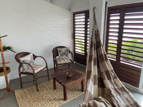 a living room with two chairs and a table at WegoKite Stars in Taíba