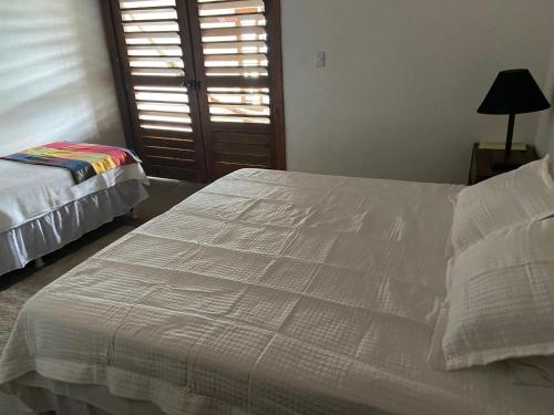 a bedroom with a white bed and a window at WegoKite Stars in Taíba
