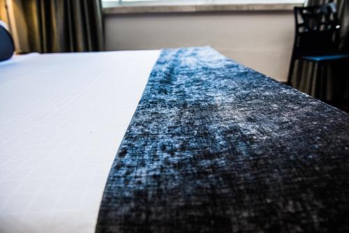 a close up of a blanket on a bed at Belaire Suites Hotel in Durban