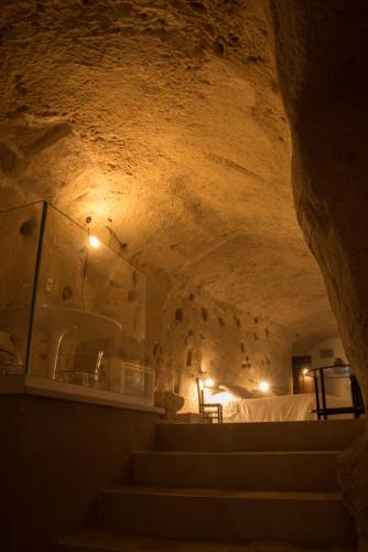 a tunnel with stairs in a cave at LA DIMORA DELLE 3 ZIE in Matera