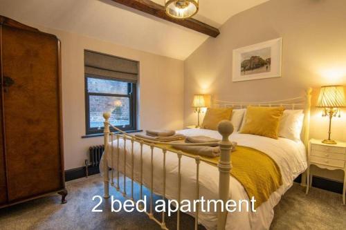 a bedroom with a bed and a window at Market Square Grade II Listed Apartment in Macclesfield