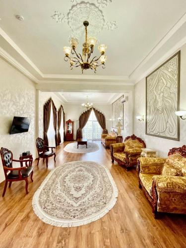 a large living room with a chandelier and a couch at Старый Бастион in Bender