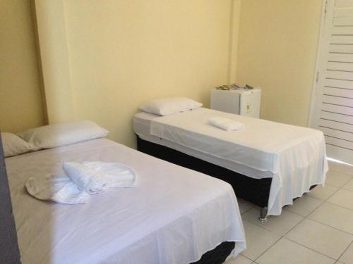 מיטה או מיטות בחדר ב-Pousada Ubajara