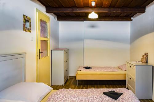 a bedroom with two beds and a window at Chalupa U Čápů in Nové Mlýny