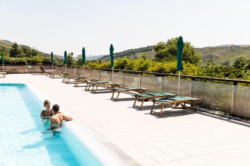 a couple in the swimming pool at a resort at Villaggio Della Salute Più in Monterenzio