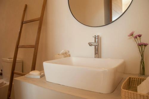 a bathroom with a white sink and a mirror at Casa Lulú in San José del Cabo