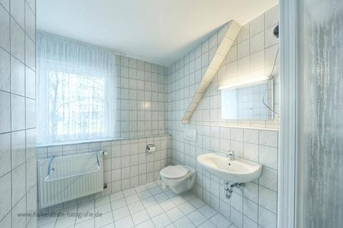 a bathroom with a toilet and a sink at Wolf, Barbara, App 2 in Zingst