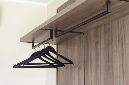 a black hanger hanging from a wooden door at Cantine De Mare - Wine and Resort in Cirò Marina