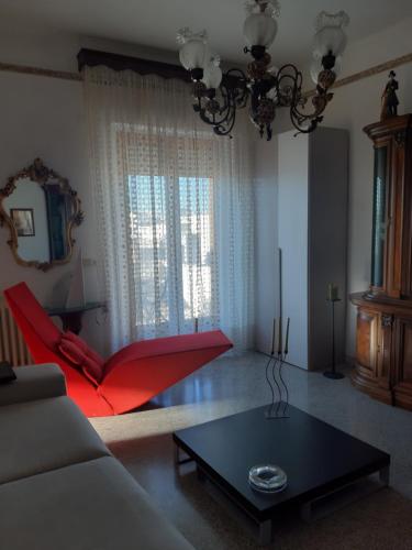 a living room with a red couch and a table at Jarubed in Alberobello