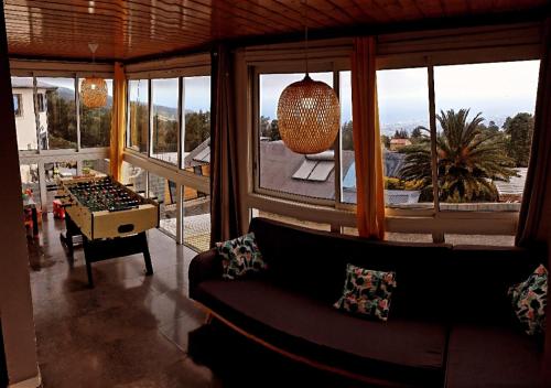 a living room with a couch and a large window at lilie97418 in La Plaine des Cafres