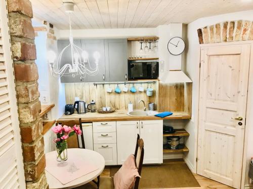 a kitchen with a table and a sink at Cozy City Veerenni studio in Tallinn