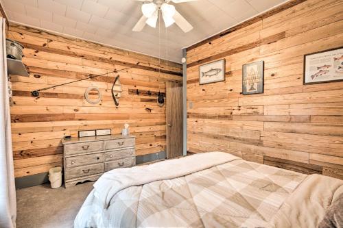 a bedroom with wooden walls and a bed and a dresser at The Olde Homestead with Mtn Views Near Coudersport in Coudersport