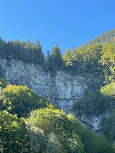 a waterfall on the side of a rocky mountain at Wasserfall Apartments Mellau in Mellau