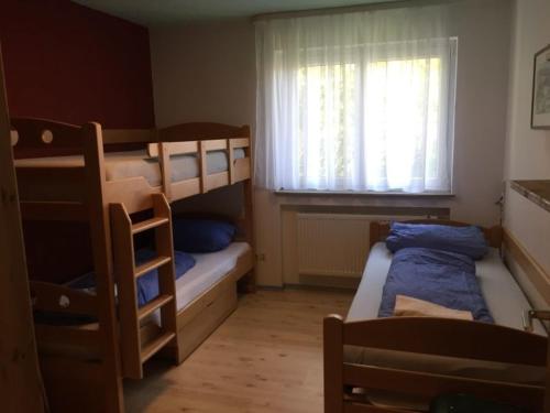 a bedroom with two bunk beds and a window at OG Villingendorf in Villingendorf