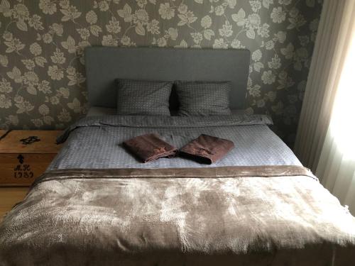 a bed with two pillows on top of it at Villa Talmo, Kimito island in Kemionsaari