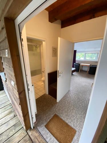 an open door into a room with a living room at K 357 - Low budget Hotel in Ratekau bei Lübeck in Ratekau