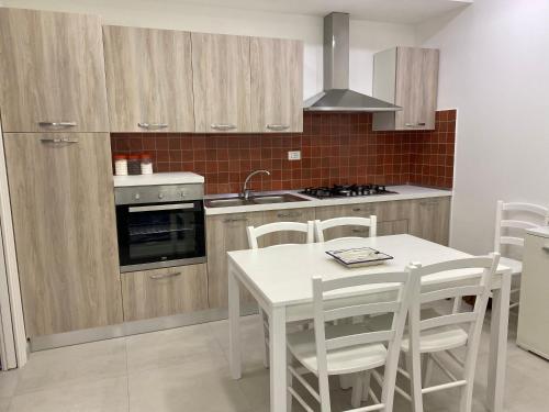 a kitchen with a white table and a stove top oven at Zaras 11 in Ischia