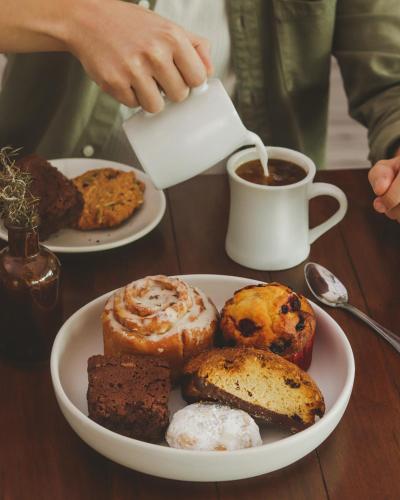 a plate of pastries and a cup of coffee on a table at La Villa de Adelina in Ensenada