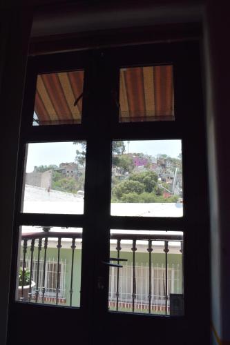 a view from a window looking out at a balcony at Sanbernabé tres in Guanajuato