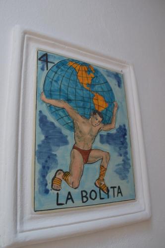 a framed picture of a man with an umbrella at Sanbernabé tres in Guanajuato
