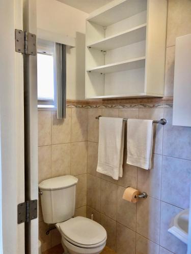 a bathroom with a toilet and a sink and towels at Apartment Hannah in Brna