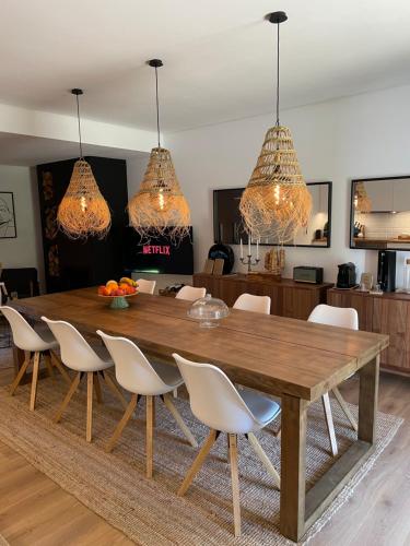 a dining room with a wooden table and chairs at Villa D’Aurora Country Suites in Ponte de Lima